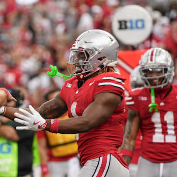 Aug 31, 2024; Columbus, OH, USA; Ohio State Buckeyes running back Quinshon Judkins (1) celebrates scoring a touchdown with quarterback Will Howard (18) during the NCAA football game against the Akron Zips at Ohio Stadium. Ohio State won 52-6.