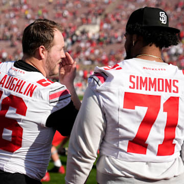 Injured Ohio State Buckeyes offensive linemen Seth McLaughlin (56) and Josh Simmons (71) watch warm ups prior to the College Football Playoff quarterfinal against the Oregon Ducks at the Rose Bowl in Pasadena, Calif. on Jan. 1, 2025. Ohio State won 41-21.