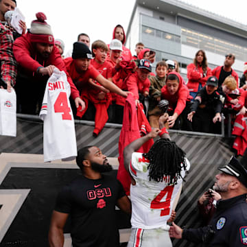 Ohio State Buckeyes wide receiver Jeremiah Smith (4) signs autographs following the NCAA football game against the Purdue Boilermakers at Ross-Ade Stadium in West Lafayette, Ind. on Nov. 8, 2025. Ohio State won 34-10.