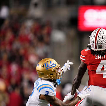Ohio State Buckeyes wide receiver Jeremiah Smith (4) makes a one-handed catch in front of UCLA Bruins defensive back Andre Jordan Jr. (2) during the NCAA football game at Ohio Stadium in Columbus on Nov. 15, 2025.