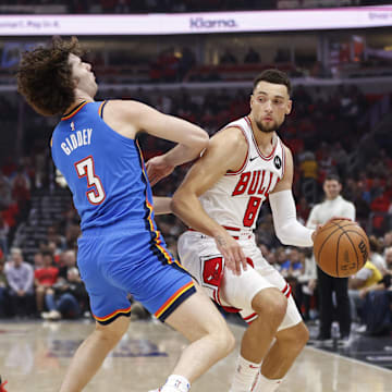 Chicago Bulls guard Zach LaVine (8) drives to the basket against Oklahoma City Thunder guard Josh Giddey (3) during the first half of a basketball game at United Center.