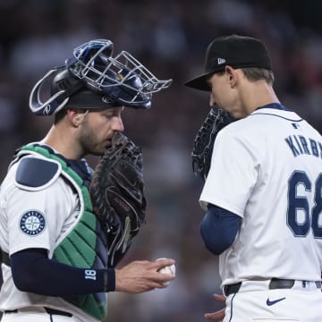 Seattle Mariners catcher Mitch Garver (18) and starting pitcher George Kirby (68) meet at the mound during the fourth inning against the Texas Rangers at T-Mobile Park.