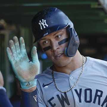 Sep 7, 2024; Chicago, Illinois, USA; New York Yankees outfielder Aaron Judge (99) celebrates with teammates in the dugout after scoring against the Chicago Cubs during the sixth inning at Wrigley Field. Mandatory Credit: Kamil Krzaczynski-Imagn Images