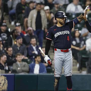 Minnesota Twins outfielder Byron Buxton (25) celebrates with shortstop Carlos Correa (4) after scoring against the Chicago White Sox during the ninth inning at Guaranteed Rate Field in Chicago on April 30, 2024.