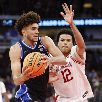 Duke’s Cameron Boozer drives to the basket against Arkansas forward Malique Ewin on Thanksgiving.