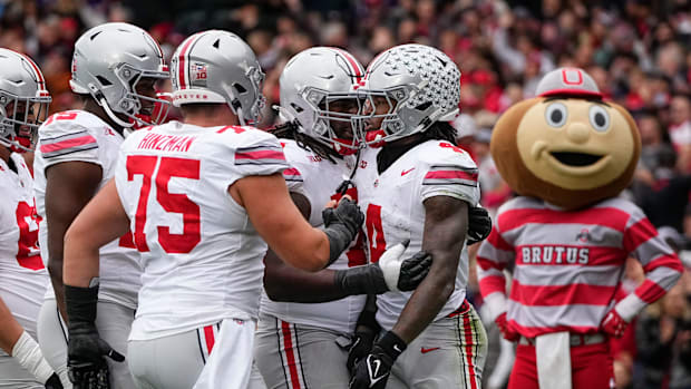 Teammates celebrate a catch by Ohio State Buckeyes wide receiver Jeremiah Smith (4) during the NCAA football game against the