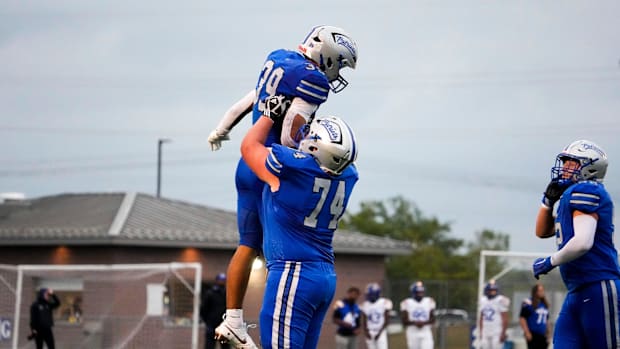Olentangy Liberty's Grayson Davis (39) celebrates with teammate Ed Nichols (74) in a win this season over Gahanna Lincoln.