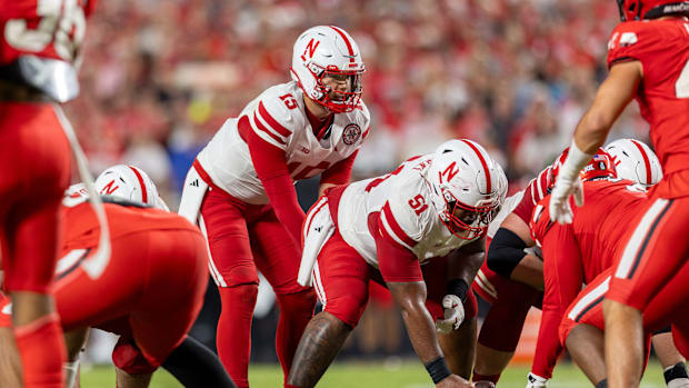 Dylan Raiola takes a snap from Justin Evans during Nebraska's 2025 game vs. Cincinnati at Arrowhead Stadium in Kansas City