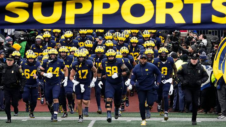 Michigan Wolverines head coach Sherrone Moore leads his team onto the field for the NCAA football game against the Ohio State Buckeyes at Michigan Stadium in Ann Arbor, Mich. on Nov. 29, 2025. Ohio State won 27-9.