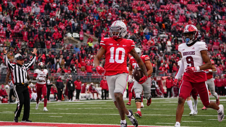 Nov 12, 2022; Columbus, Ohio, USA; Ohio State Buckeyes wide receiver Xavier Johnson (10) scores a touchdown past Indiana Hoosiers defensive back Brylan Lanier (9) on a 71-yard run during the second half of the NCAA football game at Ohio Stadium. Ohio State won 56-14. Mandatory Credit: Adam Cairns-The Columbus Dispatch

Ncaa Football Indiana Hoosiers At Ohio State Buckeyes