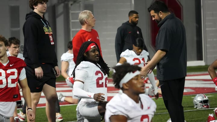 Mar 7, 2024; Columbus, OH, USA; Ohio State Buckeyes head coach Ryan Day talks to cornerback Calvin Simpson-Hunt (22) during spring football practice at the Woody Hayes Athletic Center.