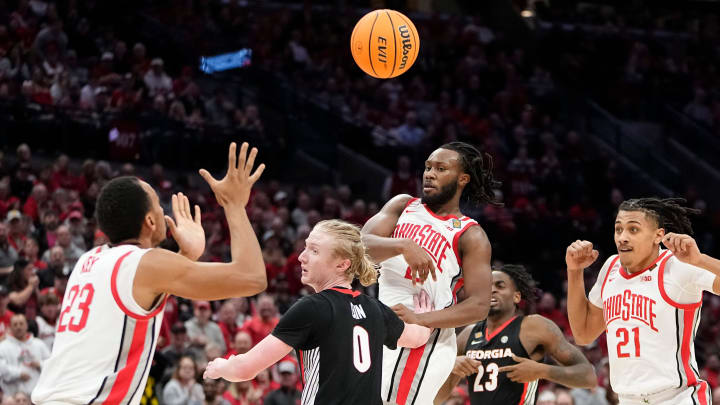 Mar 26, 2024; Columbus, OH, USA; Ohio State Buckeyes guard Bruce Thornton (2) passes over Georgia Bulldogs guard Blue Cain (0) to forward Zed Key (23) during the second half of the NIT quarterfinals at Value City Arena. Ohio State lost 79-77.