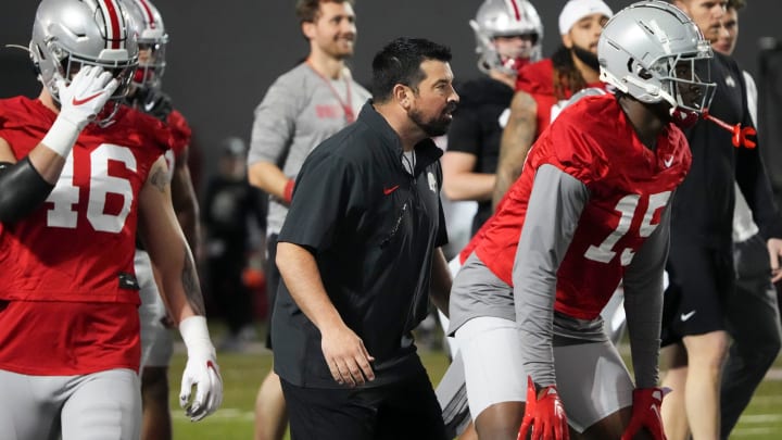 Mar 7, 2024; Columbus, OH, USA; Ohio State Buckeyes head coach Ryan Day workes with players during spring football practice at the Woody Hayes Athletic Center.