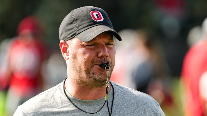 Aug 1, 2024; Columbus, OH, USA; Ohio State Buckeyes offensive line coach Justin Frye leads players during football camp at the Woody Hayes Athletic Complex.