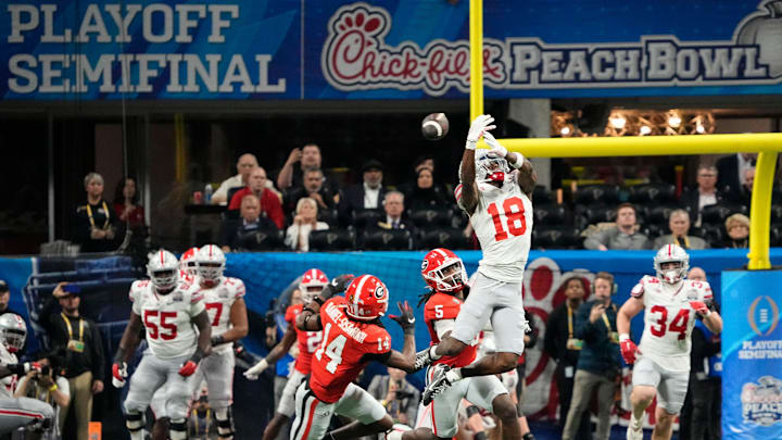 Dec 31, 2022; Atlanta, Georgia, USA;  Ohio State Buckeyes wide receiver Marvin Harrison Jr. (18) can't haul in a pass over Georgia Bulldogs defensive back David Daniel-Sisavanh (14) during the second half of the Peach Bowl in the College Football Playoff semifinal at Mercedes-Benz Stadium. Ohio State lost 42-41. Mandatory Credit: Adam Cairns-The Columbus Dispatch

Ncaa Football Peach Bowl Ohio State At Georgia