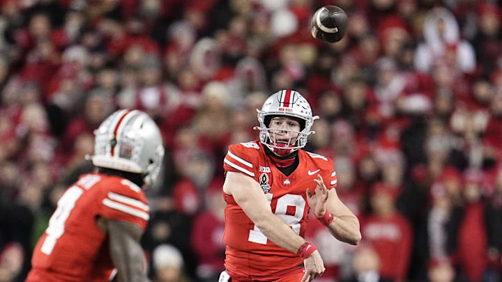 Ohio State Buckeyes quarterback Will Howard (18) throws to wide receiver Jeremiah Smith (4) during the first half of the College Football Playoff first round game against the Tennessee Volunteers at Ohio Stadium in Columbus on Dec. 21, 2024.