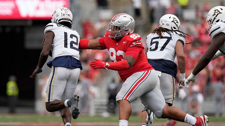 Aug 31, 2024; Columbus, OH, USA; Ohio State Buckeyes defensive tackle Hero Kanu (93) reaches to tackle Akron Zips quarterback Tahj Bullock (12) during the second half of the NCAA football game at Ohio Stadium. Ohio State won 52-6.