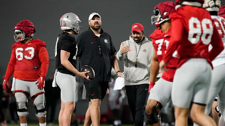 Ohio State Buckeyes offensive line coach Tyler Bowen and head coach Ryan Day talk to players during spring football practice at the Woody Hayes Athletic Center in Columbus on March 19, 2025.