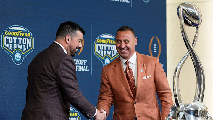 Ohio State Buckeyes head coach Ryan Day and Texas Longhorns head coach Steve Sarkisian shake hands following a press conference at AT&T Stadium prior to the College Football Playoff semifinal at the Cotton Bowl Classic in Arlington, Texas on Jan. 9, 2025.