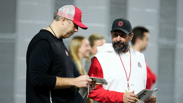 Ohio State Buckeyes offensive coordinator Arthur Smith, left, talks to defensive coordinator Matt Patricia during the first day of spring workouts for the 2026 football season at Woody Hayes Athletic Complex in Columbus on March 10, 2026.
