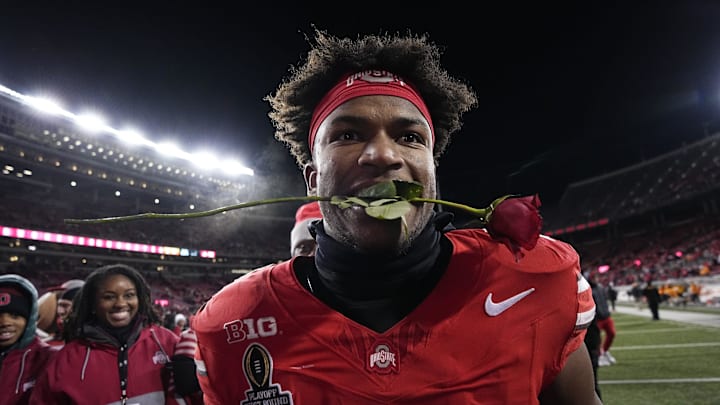 Ohio State Buckeyes safety Caleb Downs leaves the field with a rose in his mouth following the 42-17 win over the Tennessee Volunteers in the College Football Playoff first round game at Ohio Stadium in Columbus on Dec. 21, 2024. Ohio State will face Oregon in the Rose Bowl.