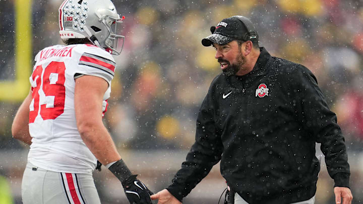 Ohio State Buckeyes head coach Ryan Day high fives tight end Will Kacmarek (89) during the NCAA football game against the Michigan Wolverines at Michigan Stadium in Ann Arbor, Mich. on Nov. 29, 2025. Ohio State won 27-9.