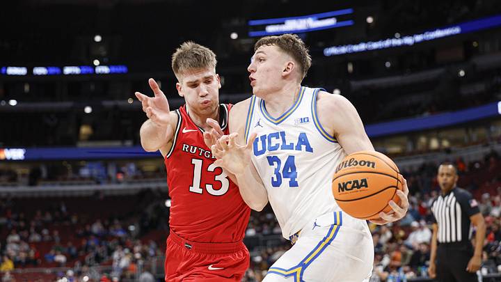 Mar 12, 2026; Chicago, IL, USA; UCLA Bruins forward Tyler Bilodeau (34) drives to the basket against Rutgers Scarlet Knights guard Harun Zrno (13) during the second half at United Center. Mandatory Credit: Kamil Krzaczynski-Imagn Images