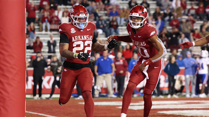 Nov 23, 2024; Fayetteville, Arkansas, USA; Arkansas Razorbacks running back Ja’Quinden Jackson (22) celebrates with quarterback Taylen Green (10) after scoring a touchdown in the fourth quarter against the Louisiana Tech Bulldogs at Donald W. Reynolds Razorback Stadium. Arkansas won 35-14. Mandatory Credit: Nelson Chenault-Imagn Images