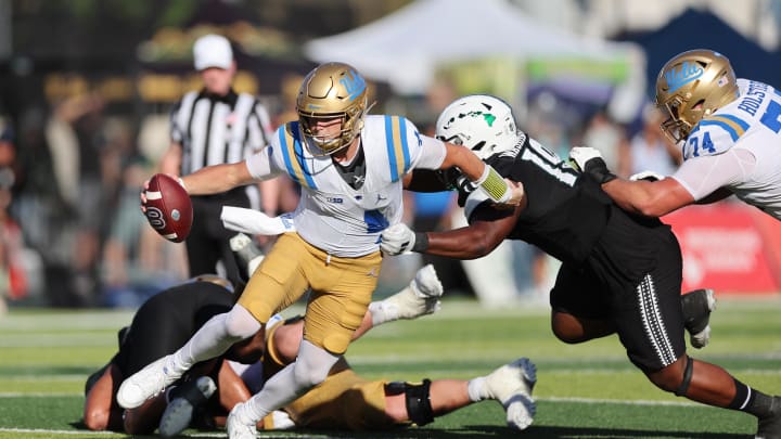 Aug 31, 2024; Honolulu, Hawaii, USA; UCLA Bruins quarterback Ethan Garbers (4) scrambles away from Hawaii Rainbow Warriors defensive lineman Dion Washington (19) during the fourth quarter of an NCAA college football game at the Clarence T.C. Ching Athletics Complex. Mandatory Credit: Marco Garcia-USA TODAY Sports