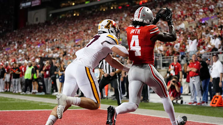 Ohio State Buckeyes wide receiver Jeremiah Smith (4) catches a touchdown pass in front of Minnesota Golden Gophers defensive back John Nestor (17) during the first half of the NCAA football game at Ohio Stadium in Columbus on Oct. 4, 2025. Ohio State Buckeyes wide receiver Jeremiah Smith (4) catches a touchdown pass in front of Minnesota Golden Gophers defensive back John Nestor (17) during the first half of the NCAA football game at Ohio Stadium in Columbus on Oct. 4, 2025.