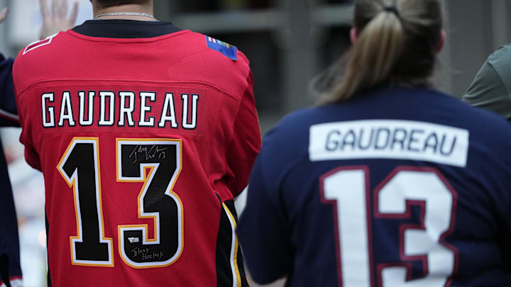 Aug 30, 2024; Columbus, OH, USA; Mourners gather outside Nationwide Arena at a makeshift memorial for Columbus Blue Jackets forward Johnny Gaudreau. Gaudreau and his brother, Matthew, were killed in a bicycle accident the night before. Mandatory Credit: Adam Cairns/Columbus Dispatch-USA TODAY Network