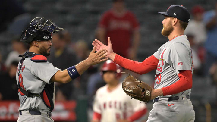 May 13, 2024; Anaheim, California, USA;   St. Louis Cardinals catcher Ivan Herrera (48) shakes hands with relief pitcher Nick Robertson (29) after ninth inning defeating the Los Angeles Angels at Angel Stadium. Mandatory Credit: Jayne Kamin-Oncea-USA TODAY Sports