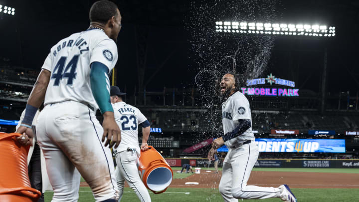 May 29, 2024; Seattle, Washington, USA; Seattle Mariners shortstop J.P. Crawford (3), right, celebrates with centerfielder Julio Rodriguez (44) and Ty France (23) after a game against the Houston Astros at T-Mobile Park. Mandatory Credit: Stephen Brashear-USA TODAY Sports