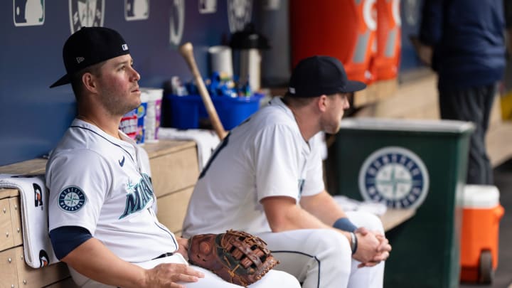 Seattle Mariners first baseman Ty France (23), left, and left fielder Luke Raley (20) sit in the dugout before a game against the Kansas City Royals at T-Mobile Park on May 13.