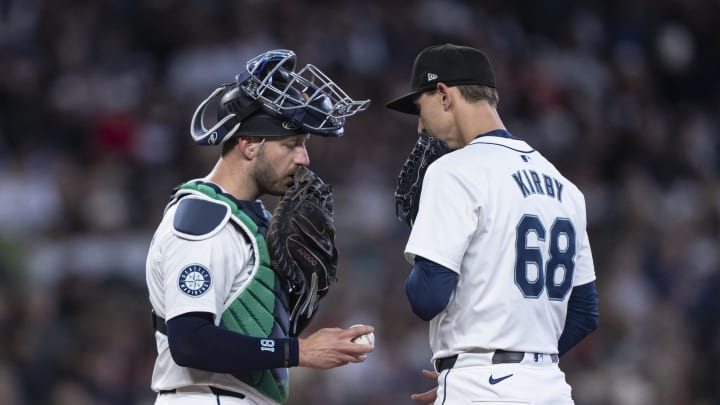 Seattle Mariners catcher Mitch Garver (18) and starting pitcher George Kirby (68) meet at the mound during the fourth inning against the Texas Rangers at T-Mobile Park on June 19.