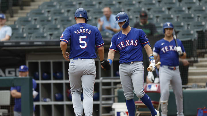 Aug 28, 2024; Chicago, IL, USA; Texas Rangers shortstop Corey Seager (5) celebrates with third baseman Josh Jung (6) after scoring against the Chicago White Sox during the first inning of game one of the doubleheader at Guaranteed Rate Field. Mandatory Credit: Kamil Krzaczynski-USA TODAY Sports