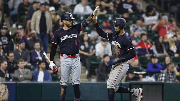 Minnesota Twins outfielder Byron Buxton (25) celebrates with shortstop Carlos Correa (4) after scoring against the Chicago White Sox during the ninth inning at Guaranteed Rate Field in Chicago on April 30, 2024.