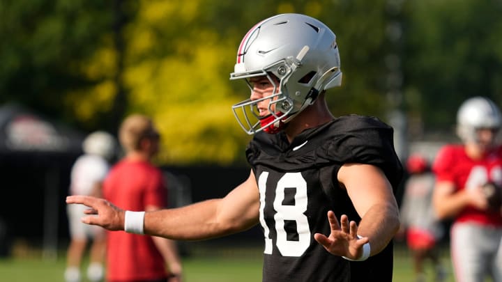 Aug 8, 2024; Columbus, Ohio, USA; Ohio State Buckeyes quarterback Will Howard (18) takes a snap during football practice at the Woody Hayes Athletic Complex.