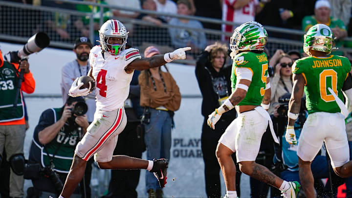 Ohio State Buckeyes wide receiver Jeremiah Smith (4) scores a touchdown in front of Oregon Ducks defensive back Kobe Savage (5) and defensive back Tysheem Johnson (0) during the first half of the College Football Playoff quarterfinal at the Rose Bowl in Pasadena, Calif. on Jan. 1, 2025. Ohio State Buckeyes wide receiver Jeremiah Smith (4) scores a touchdown in front of Oregon Ducks defensive back Kobe Savage (5) and defensive back Tysheem Johnson (0) during the first half of the College Football Playoff quarterfinal at the Rose Bowl in Pasadena, Calif. on Jan. 1, 2025.