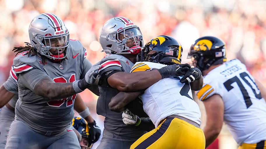 Ohio State Buckeyes safety Sonny Styles tackles Iowa Hawkeyes running back Kaleb Johnson.