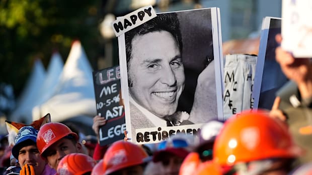 A sign featuring a young Lee Corso is held by a fan during ESPN’s ‘College GameDay.’