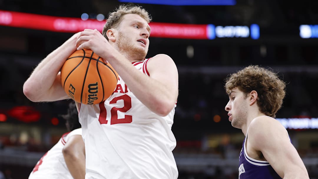 Mar 11, 2026; Chicago, IL, USA; Indiana Hoosiers forward Tucker Devries (12) grabs a rebound against the Northwestern Wildcats during the first half at United Center. Mandatory Credit: Kamil Krzaczynski-Imagn Images