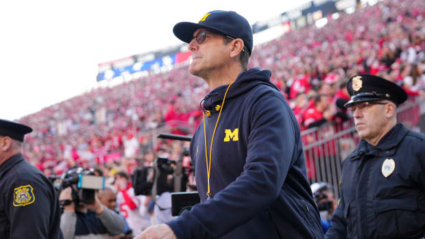 Michigan Wolverines head coach Jim Harbaugh walks onto the field rior to the NCAA football game against the Ohio State Buckey