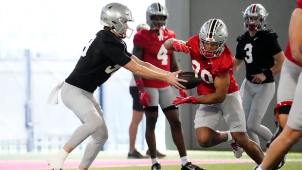 Running back takes handoff from quarterback.