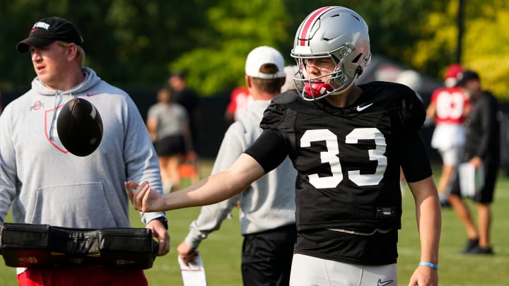 Aug 8, 2024; Columbus, Ohio, USA; Ohio State Buckeyes quarterback Devin Brown (33) tosses a ball during football practice at the Woody Hayes Athletic Complex.