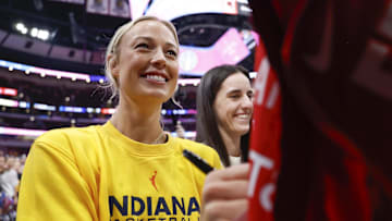 Jul 27, 2025; Chicago, Illinois, USA; Indiana Fever guards Sophie Cunningham (8) and Caitlin Clark (22)sign autographs before a WNBA game against the Chicago Sky at United Center. Mandatory Credit: Kamil Krzaczynski-Imagn Images