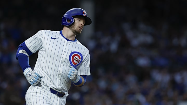 Sep 2, 2024; Chicago, Illinois, USA; Chicago Cubs outfielder Ian Happ (8) runs after hitting a single against the Pittsburgh Pirates during the third inning at Wrigley Field. 