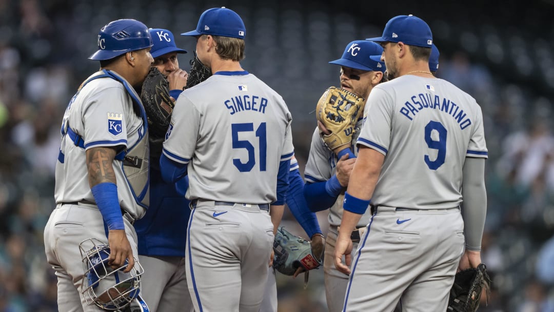 May 13, 2024; Seattle, Washington, USA; Kansas City Royals catcher Salvador Perez (13), left, pitching coach Brian Sweeney, second from left, starting pitcher Brady Singer (51), shortstop Bobby Witt Jr. (7), and first baseman Vinnie Pasquantino (9) meet at the mound during the second inning against the Seattle Mariners at T-Mobile Park. Mandatory Credit: Stephen Brashear-USA TODAY Sports