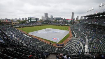 Jun 1, 2024; Chicago, Illinois, USA; A tarp covers the infield during the rain delay before a baseball game between the Chicago Cubs and Cincinnati Reds at Wrigley Field. Mandatory Credit: Kamil Krzaczynski-USA TODAY Sports