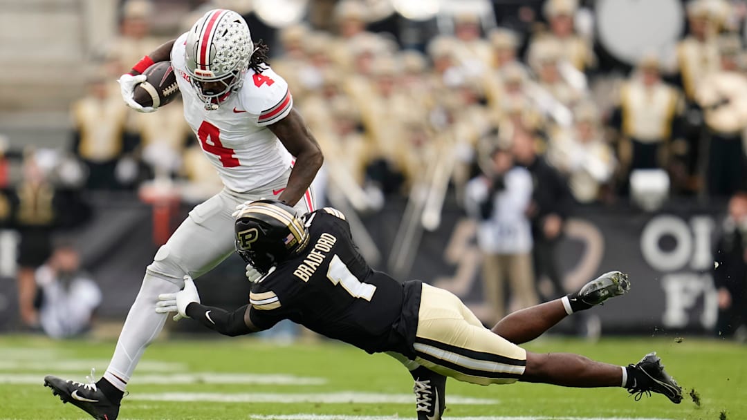Ohio State Buckeyes wide receiver Jeremiah Smith (4) runs over Purdue Boilermakers defensive back Smiley Bradford (1) during the NCAA football game at Ross-Ade Stadium in West Lafayette, Ind. on Nov. 8, 2025.